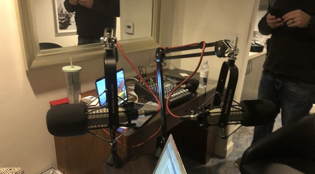 Two microphones, laptops and a mixer arranged for Jennifer Neeley's guest-host appearance with Bob Ruff.